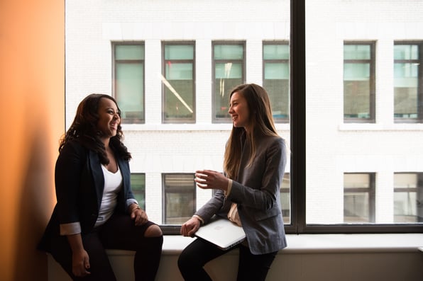 Coworkers Discussing Sitting Near black Full-glass Panel Window